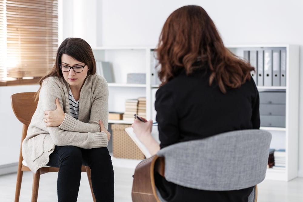 woman talking to therapist about PTSD