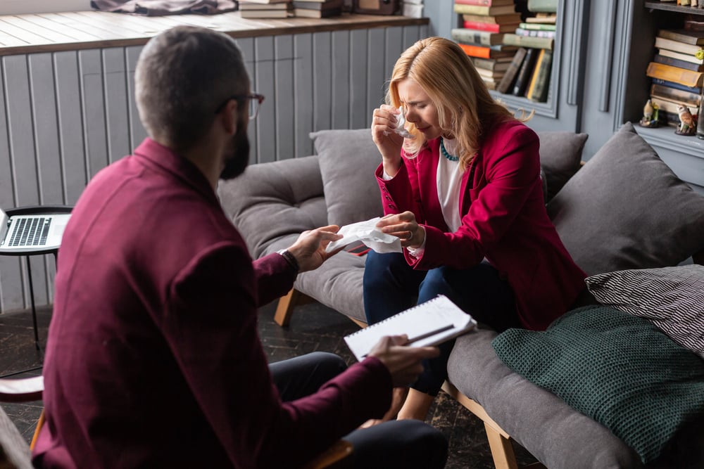 therapist helping a woman to get over grief and acceptance