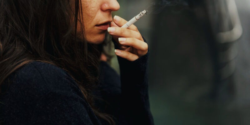 a woman experiencing stress and smoking