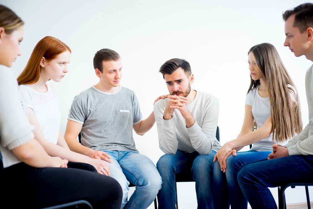 man with complex ptsd and addiction discussing it at his group therapy session