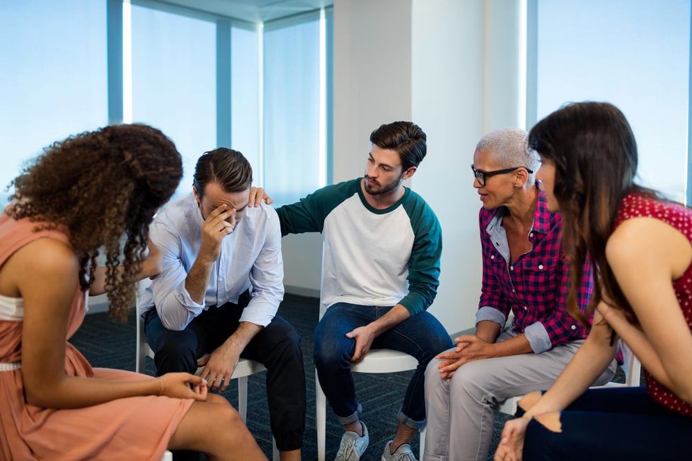 man with trauma having an emotional discussion at a group therapy session