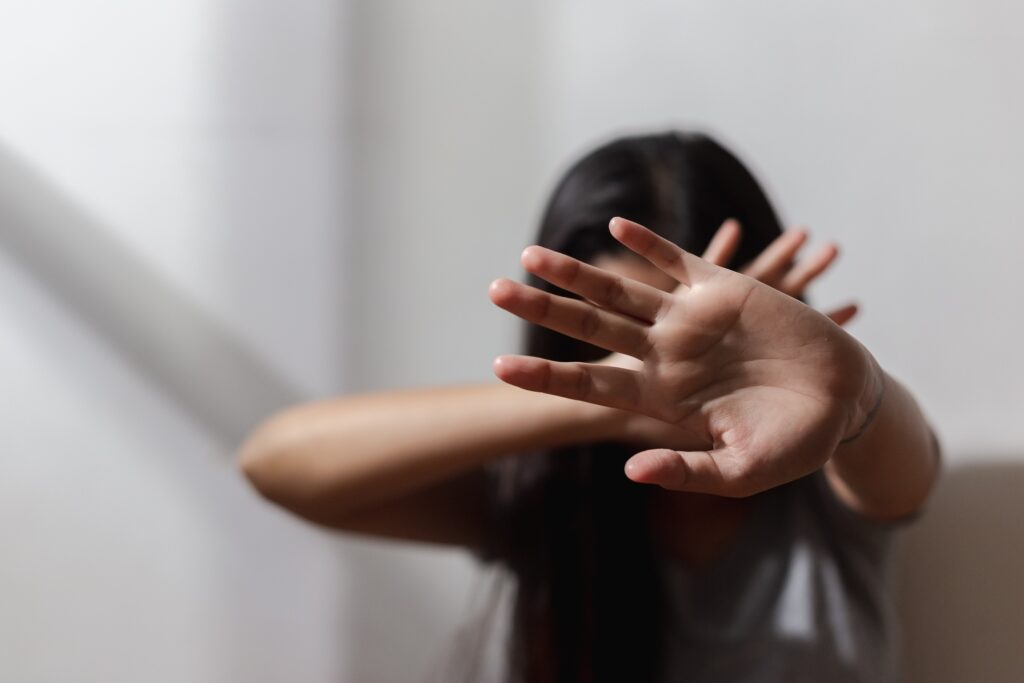 Close up focus of hand woman showing to stop violence fear abuse. domestic pain, trafficking concept.