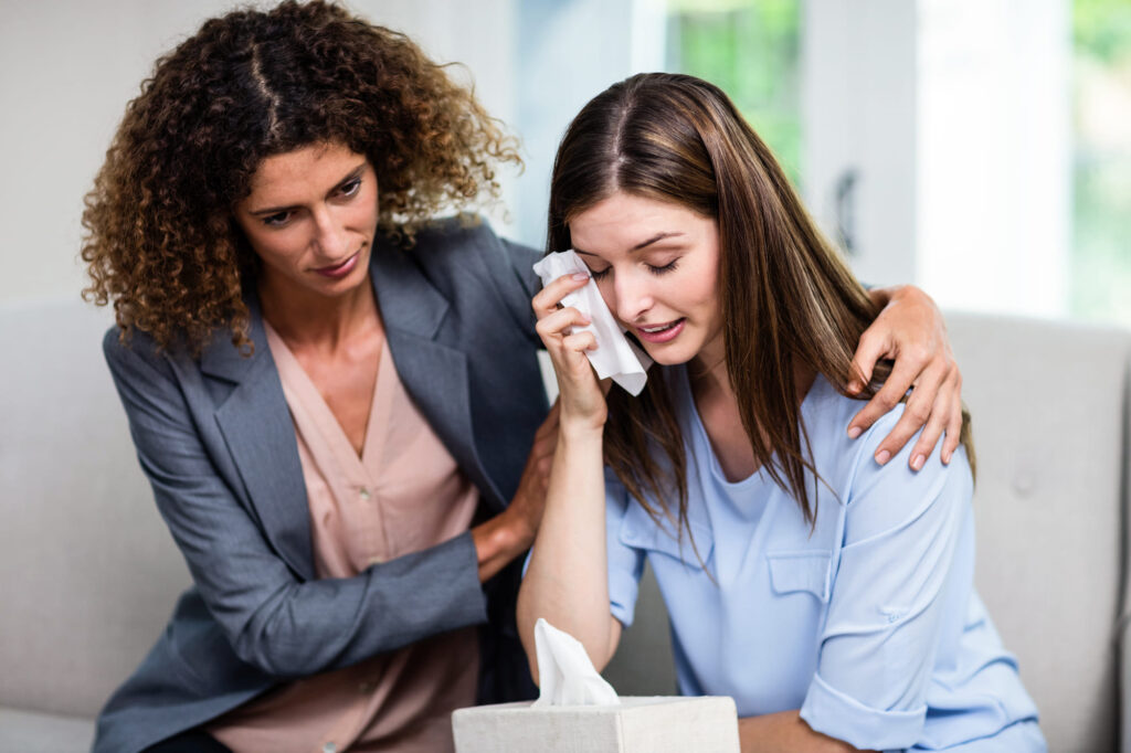 a therapist giving comfort to her trauma patient.