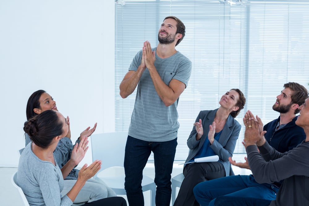 man proud to be releasing his trauma experience with others in group therapy