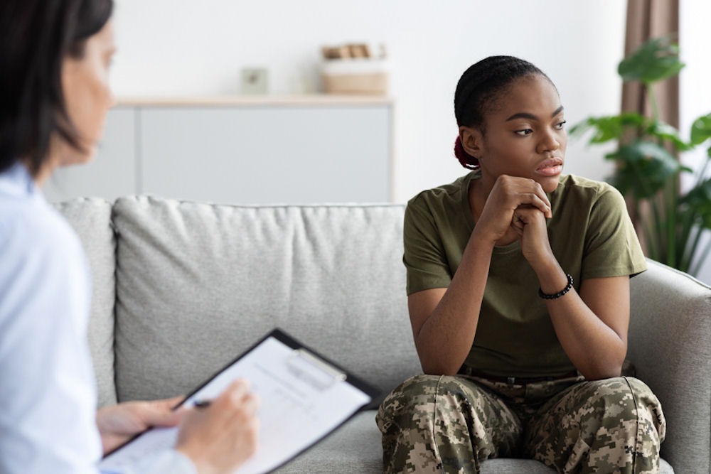 a therapist explaining to the woman the common ptsd triggers