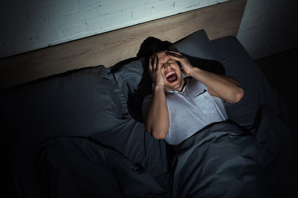 man having ptsd nightmares