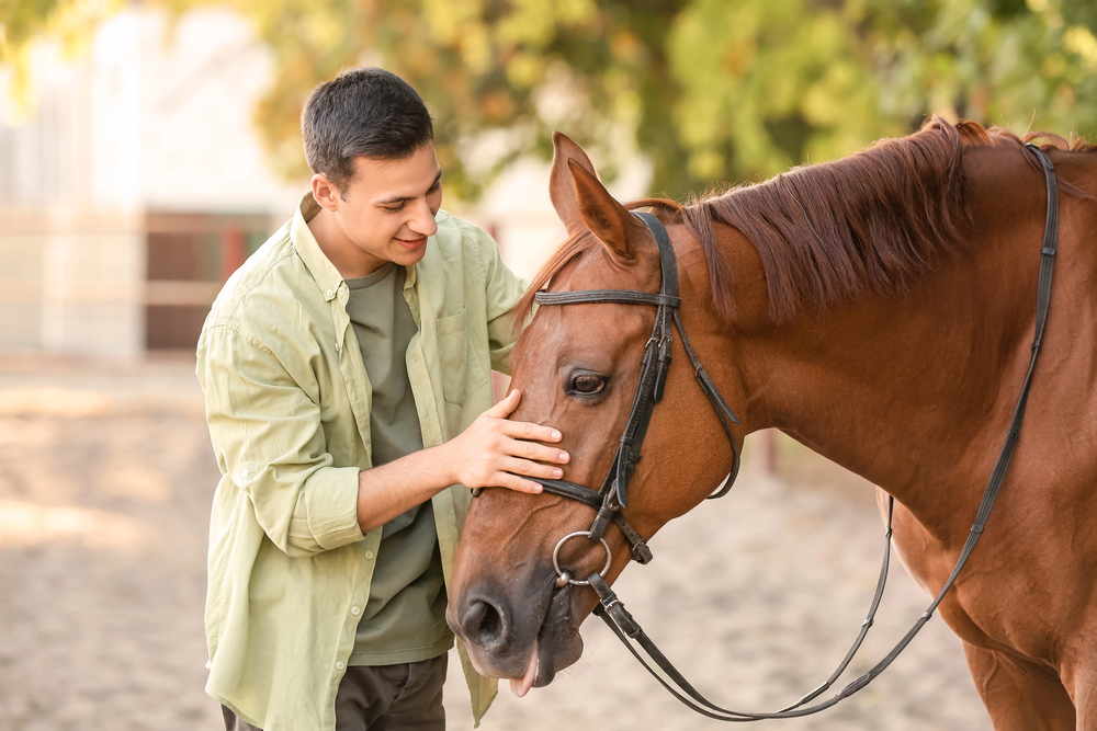 man undergoing equine therapy