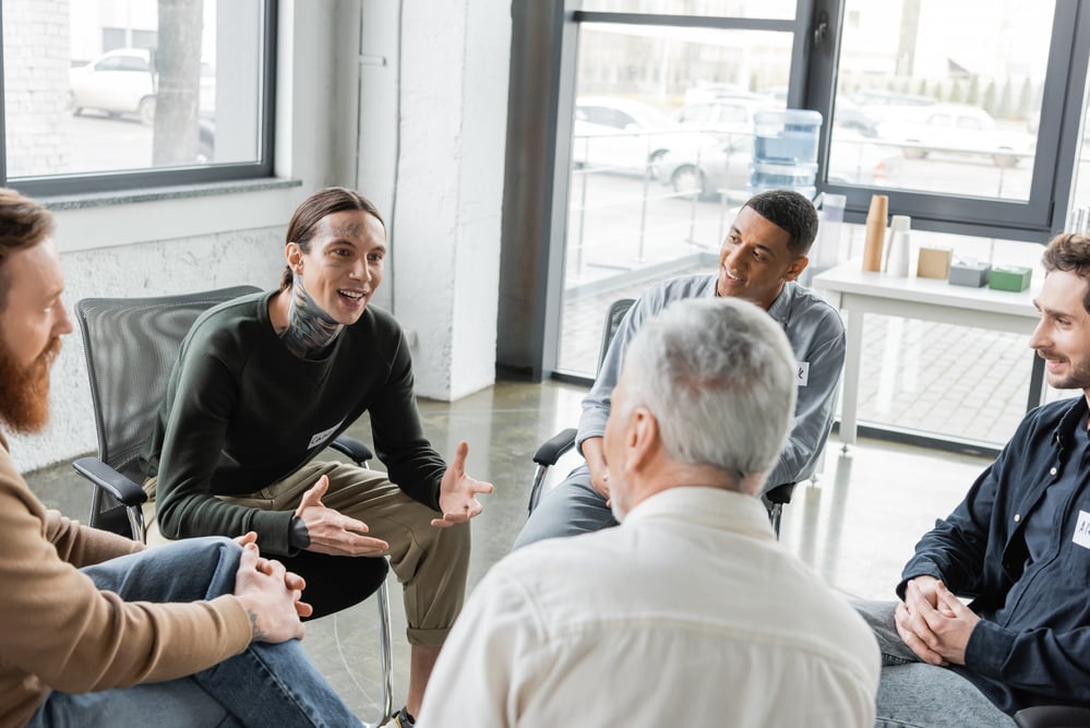 man explaining brain wave therapy to his group