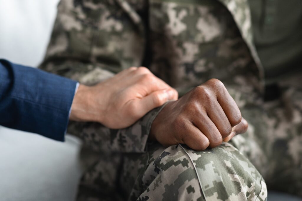 psychologist comforting military man during PTSD Therapy session