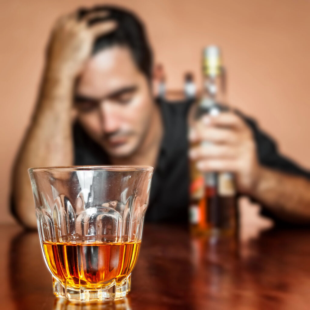 man scratching head rash due to alcohol drinking