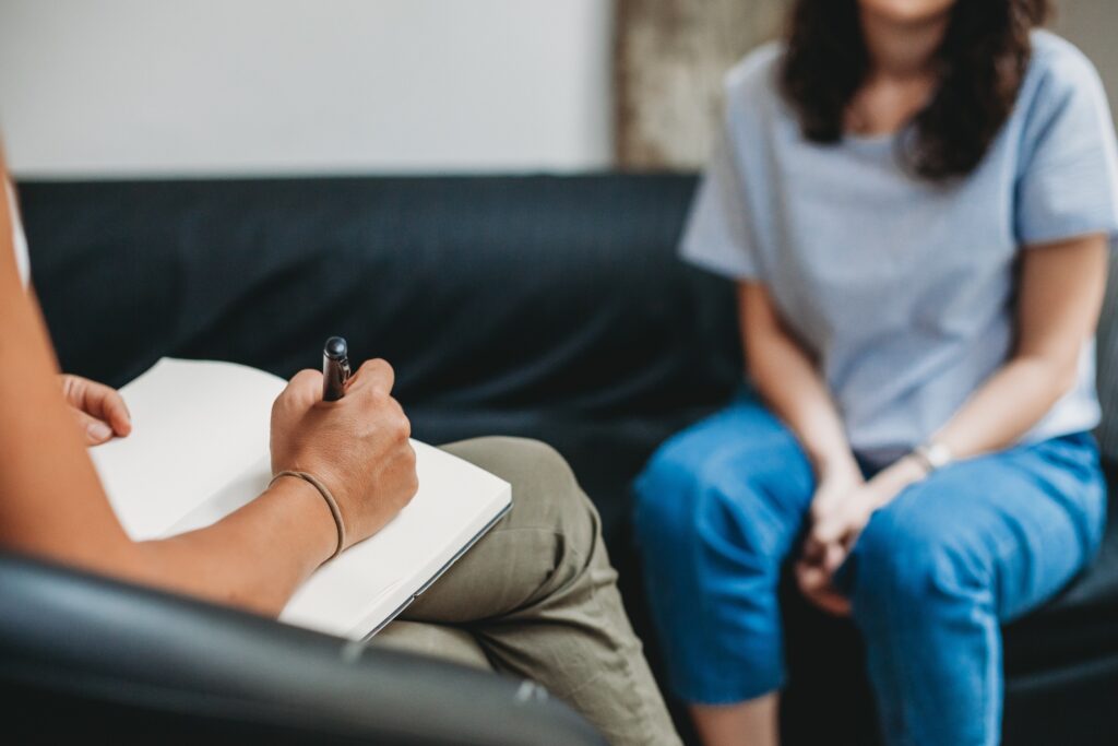 woman talking to her psychologist in the about her PTSD problem