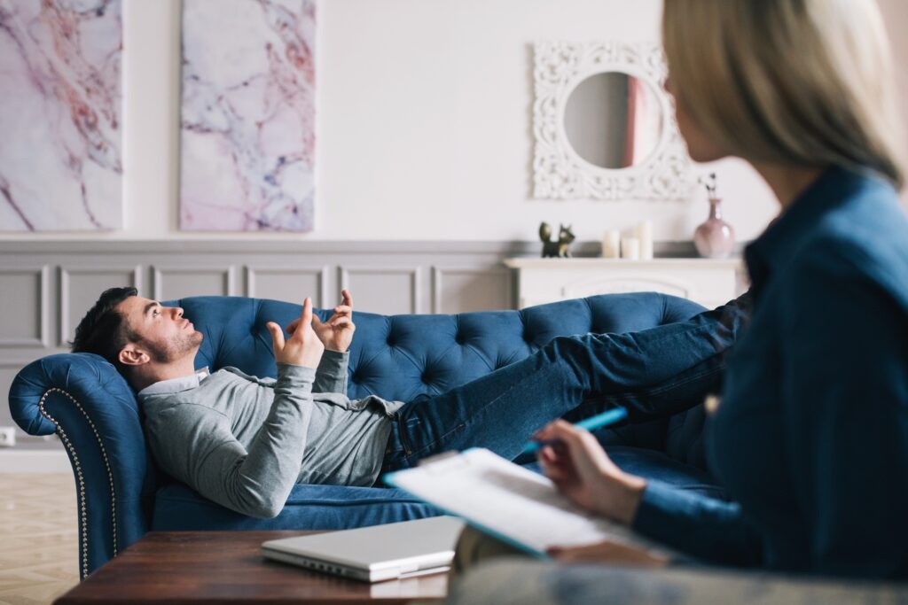 man diagnosed with PTSD talking with psychologist 