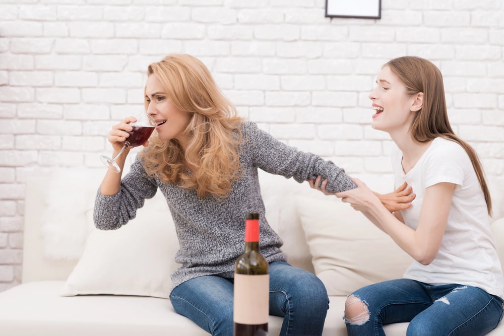 daughter stopping her alcoholic parent from drinking