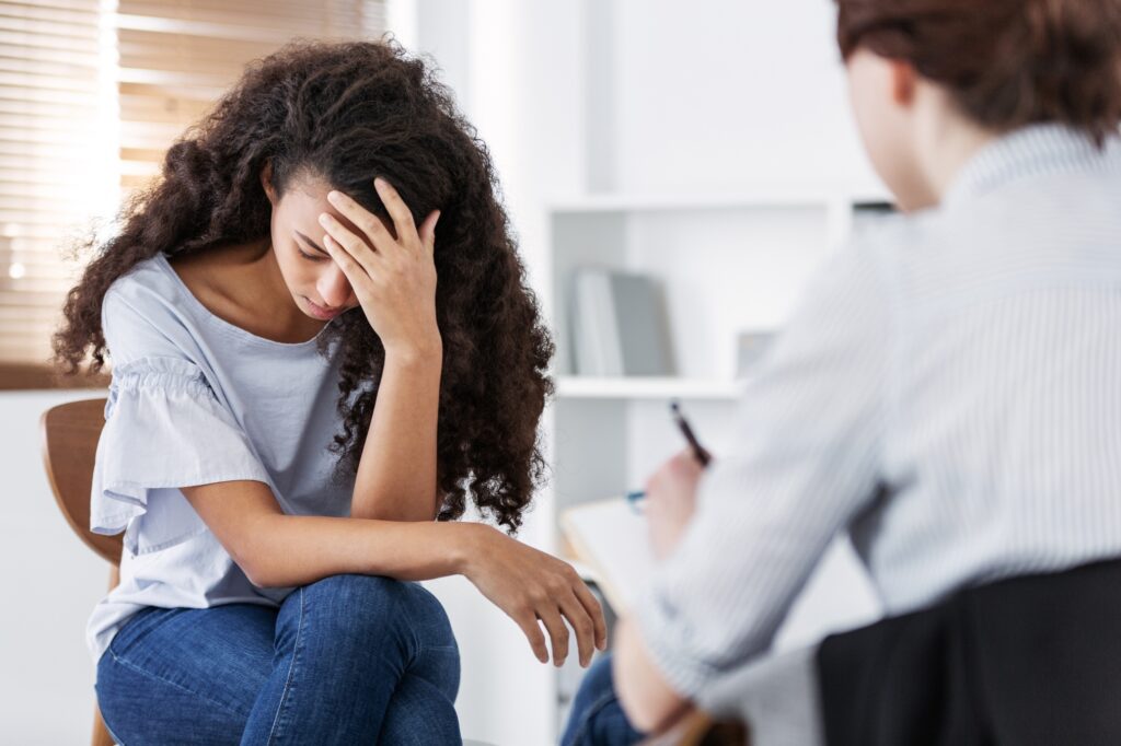 professional psychotherapies and young woman suffering from ptsd