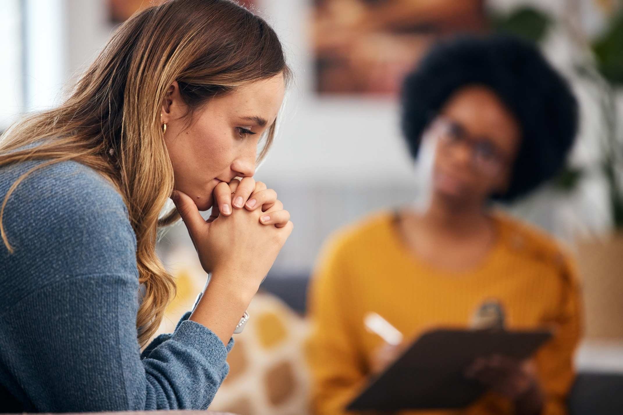 woman in therapy with healthcare professional for ptsd related