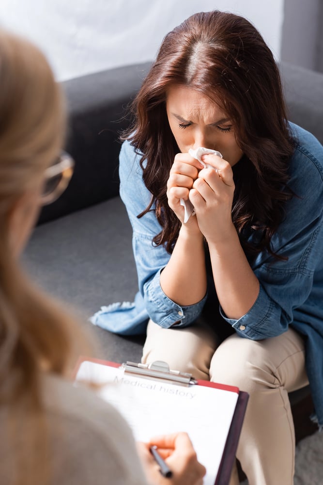 A woman crying during a therapy session for depression.