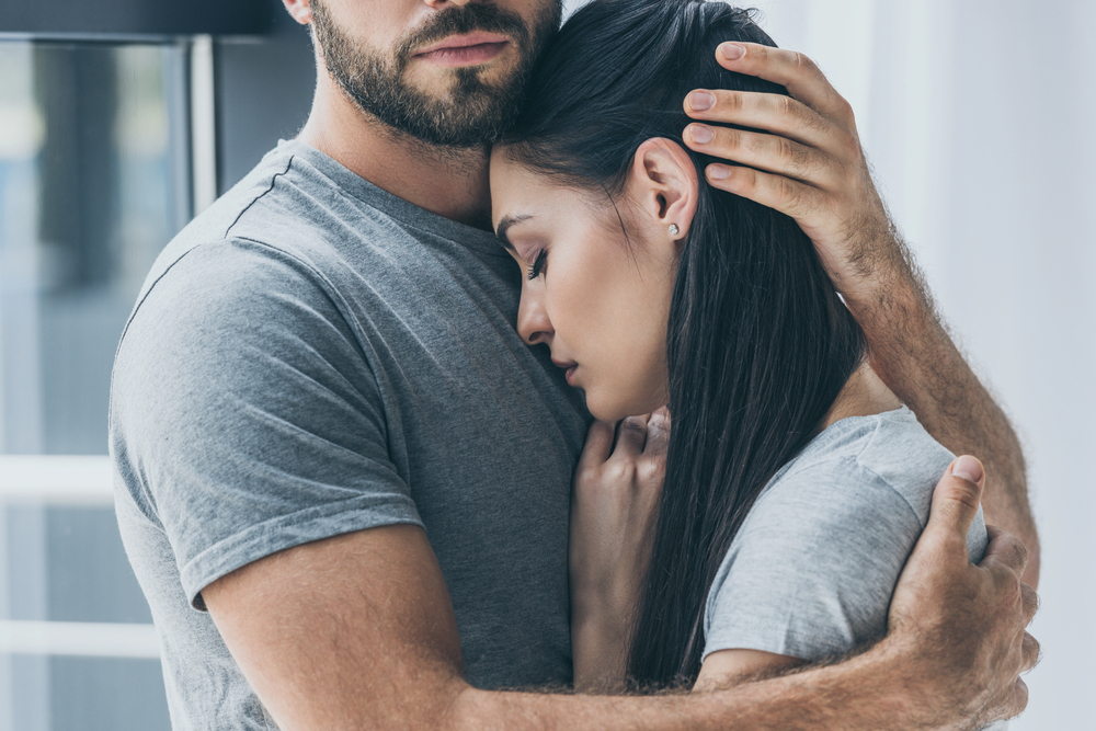 Couple embracing through relationship depression struggles