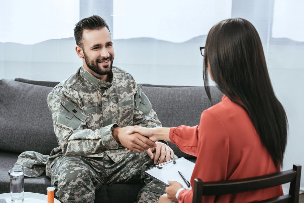 A soldier smiling during a therapy session addressing PTSD