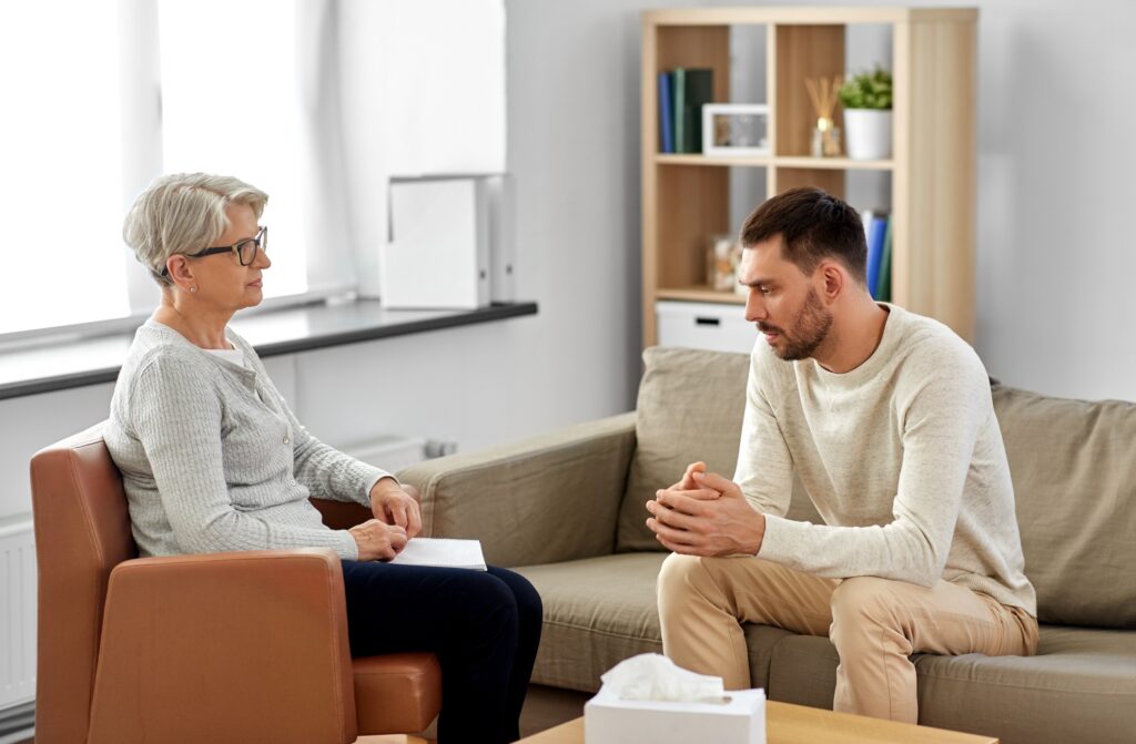 senior woman psychologist and young PTSD patient