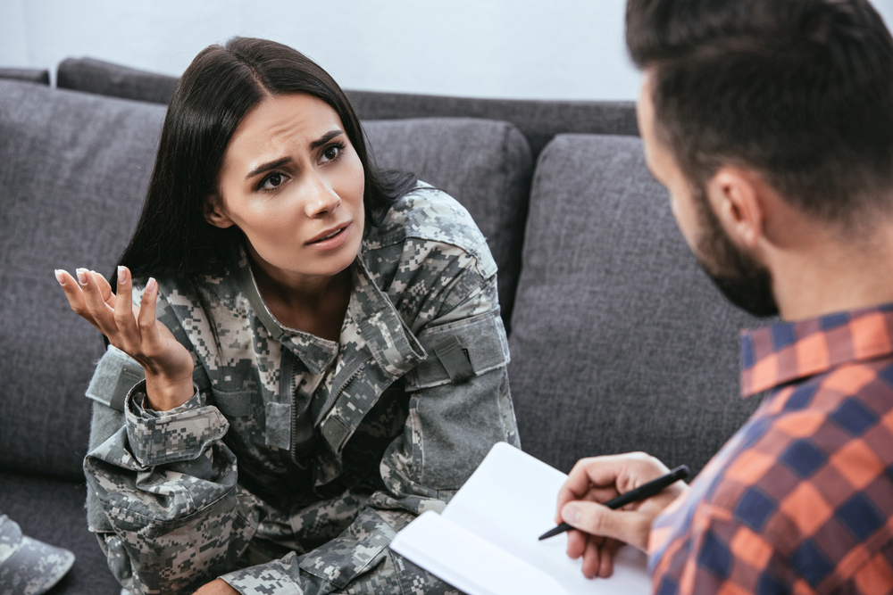 counselor attentively listening to a woman soldier