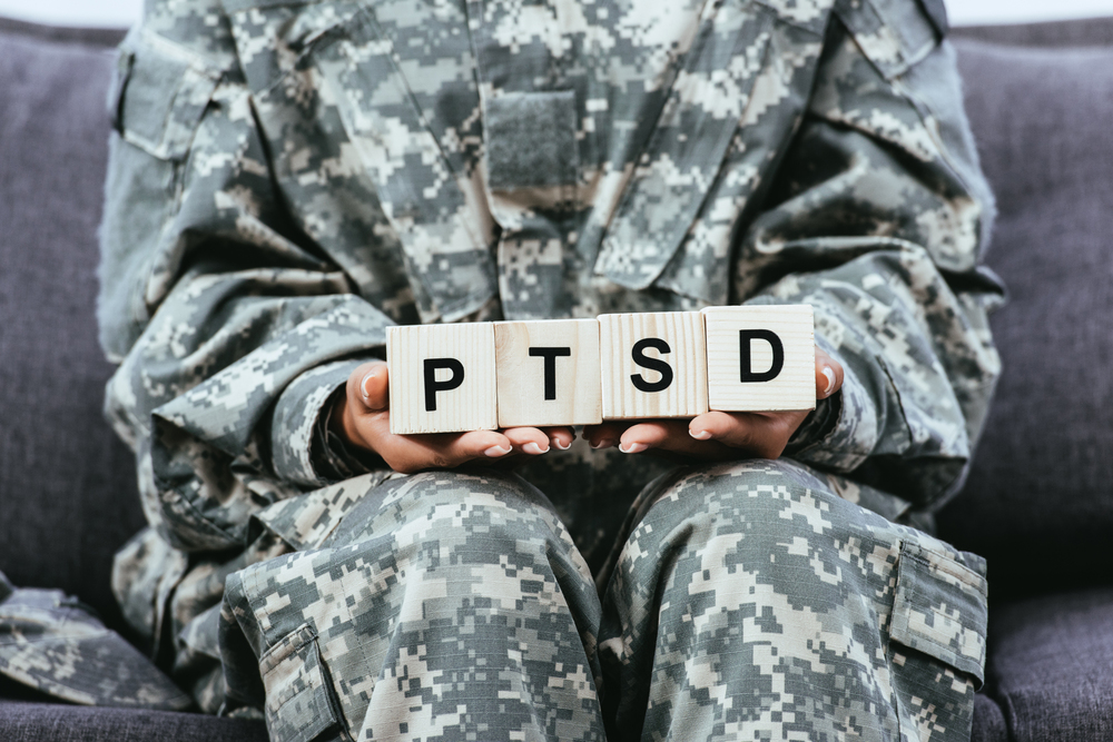 soldier holding PTSD sign