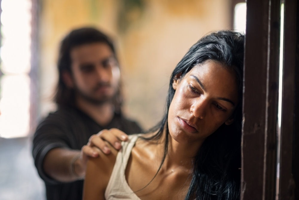 man comforting sad woman