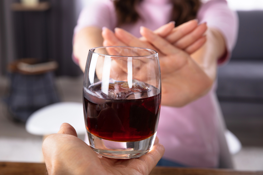 woman saying no to alcohol ready to experience the immediate health benefits of quitting