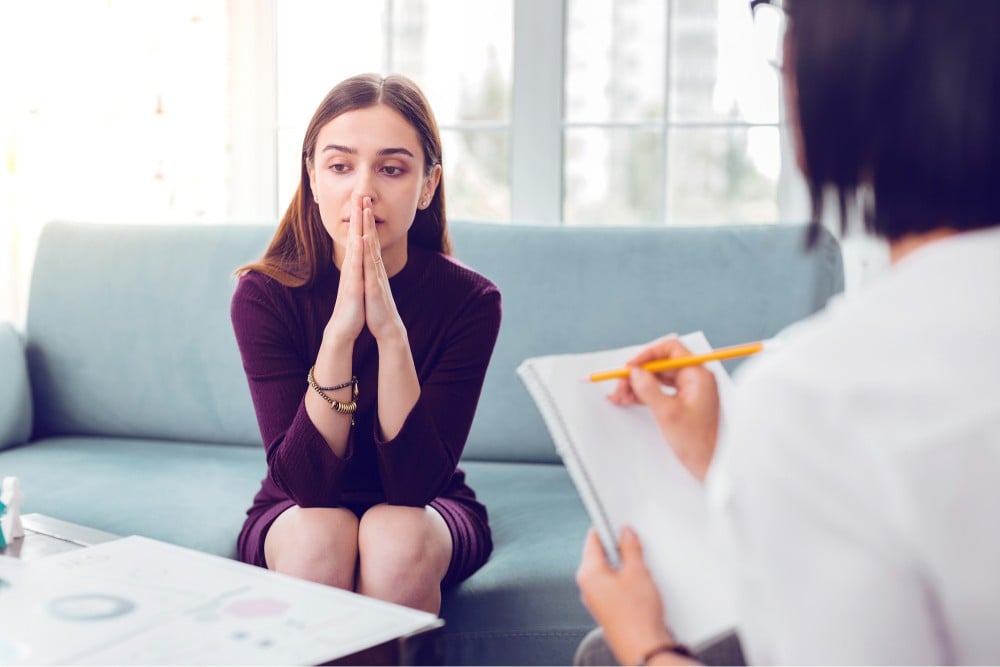 young depressed woman in a mental health session