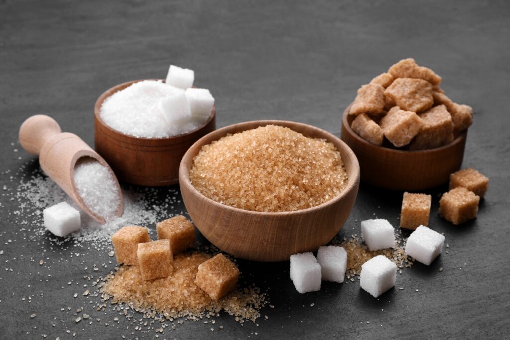 Different types of sugar on black table