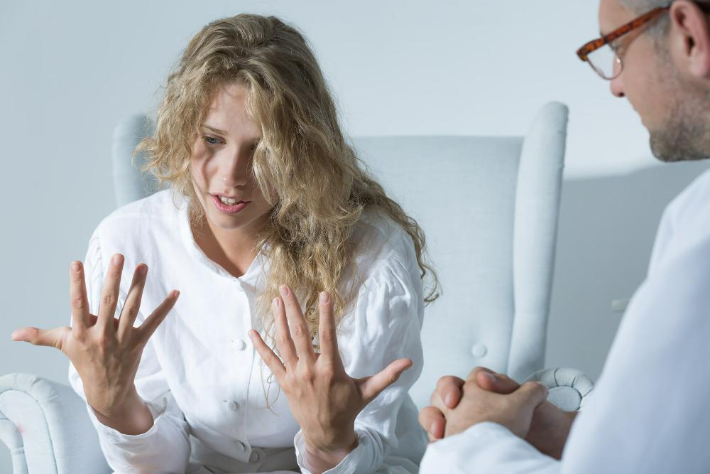 woman talking to a therapist on her trauma