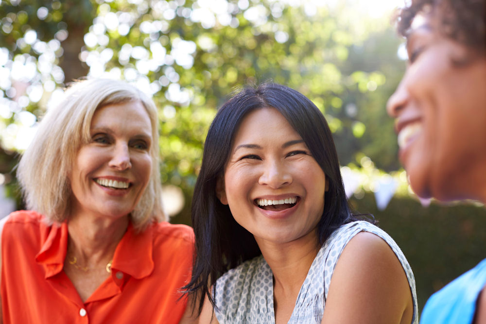 women smiling at each other