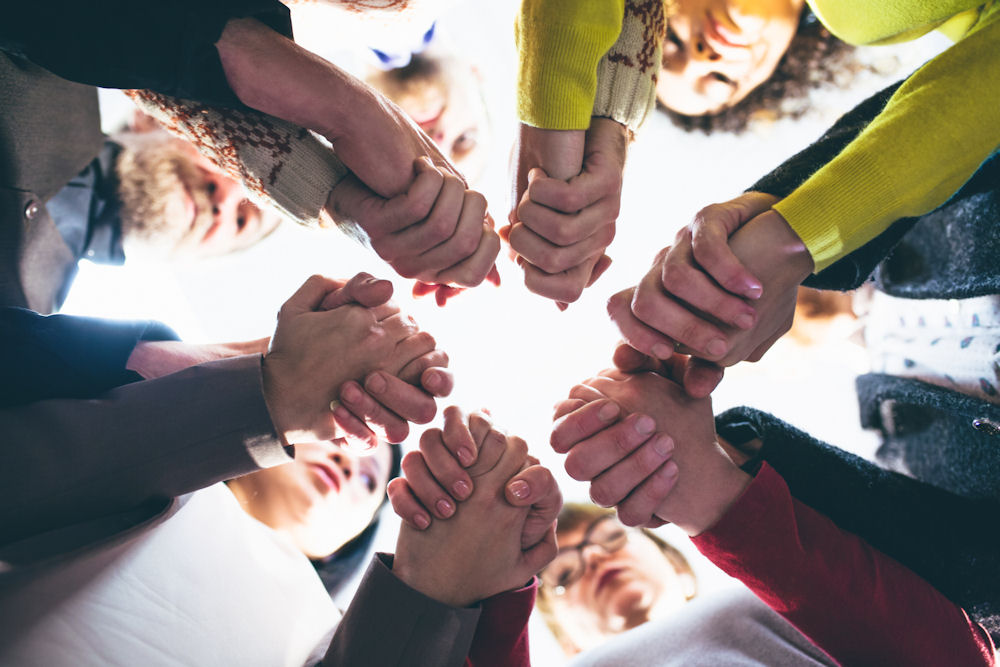 small group holding hands