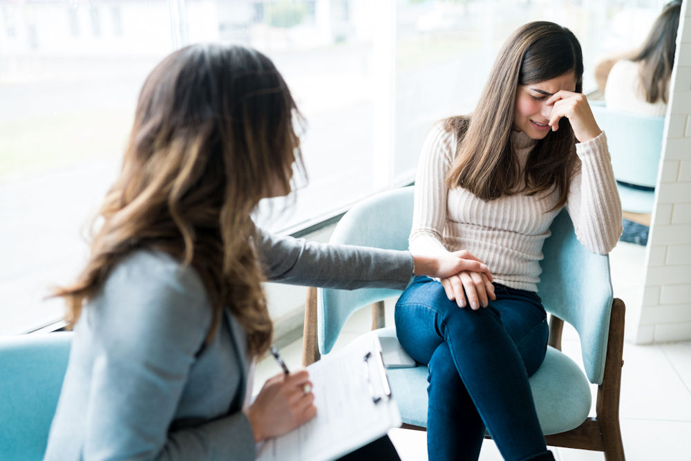 woman counselor comforting female patient