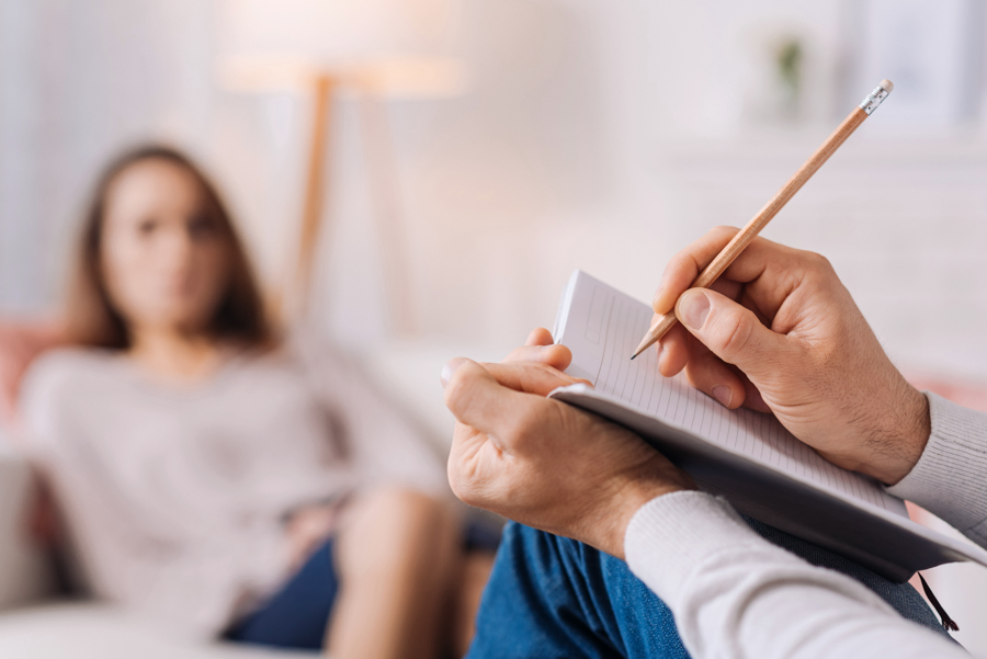 therapist taking notes during session