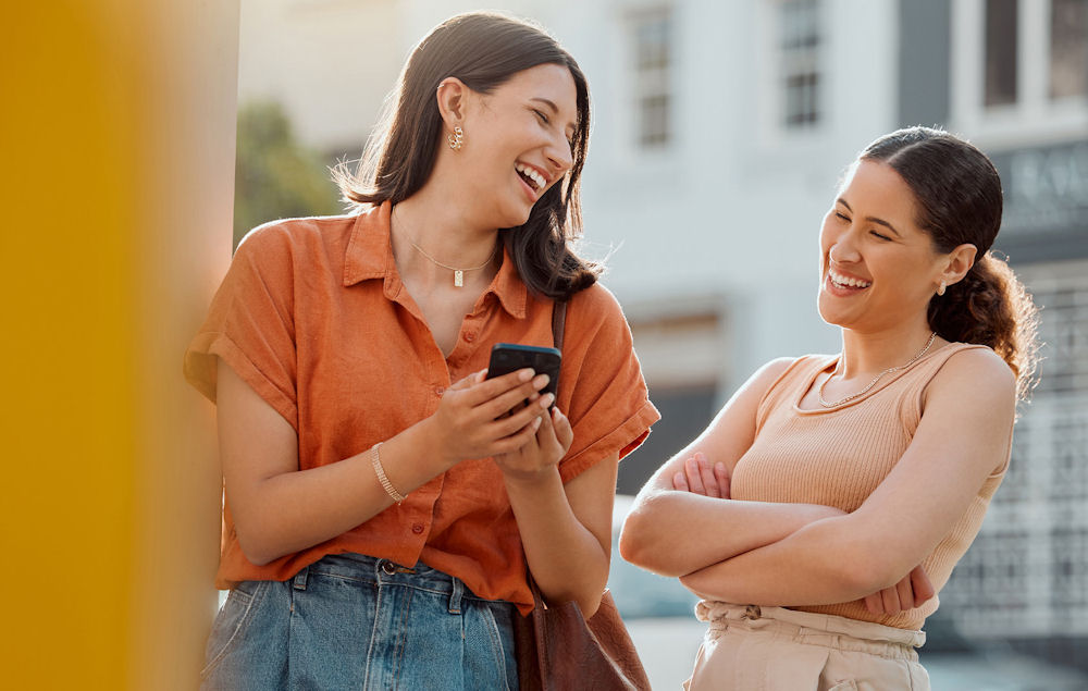 women outside laughing together